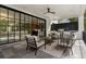 Outdoor patio with black-framed sliding glass doors, kitchen, seating, fan, and elegant decor at 42 Blackland Nw Rd, Atlanta, GA 30342