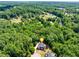 Aerial view of the property nestled within lush greenery, showcasing its serene and private location at 6690 Bridge Brook Ovlk, Cumming, GA 30028