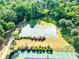 Aerial view of community basketball court surrounded by lush greenery and landscaping at 6690 Bridge Brook Ovlk, Cumming, GA 30028