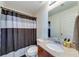 Neutral bathroom featuring a shower and bathtub combination, vanity and a large mirror above the sink at 6690 Bridge Brook Ovlk, Cumming, GA 30028