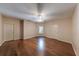 Bright bedroom featuring hardwood floors, a modern ceiling fan, and two entry doors at 6690 Bridge Brook Ovlk, Cumming, GA 30028