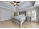 Spacious bedroom with a tray ceiling, decorative furniture and a door to the back deck at 6690 Bridge Brook Ovlk, Cumming, GA 30028