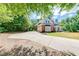 Long driveway leading to a beautiful home with lush landscaping, offering privacy at 6690 Bridge Brook Ovlk, Cumming, GA 30028