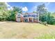 Beautiful two-story home with a well-manicured lawn and lush green trees at 6690 Bridge Brook Ovlk, Cumming, GA 30028