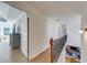 An open hallway leading to a fireplace with a view of the large windows of the exterior at 6690 Bridge Brook Ovlk, Cumming, GA 30028