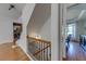 Hallway featuring wood floors and stairs at 6690 Bridge Brook Ovlk, Cumming, GA 30028