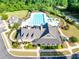 Aerial view of the community pool and clubhouse featuring a splash pad, lounge chairs, and manicured grounds at 6690 Bridge Brook Ovlk, Cumming, GA 30028