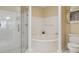 The bathroom offers a glass enclosed shower and tub at 220 Renaissance Ne Pkwy # 1205, Atlanta, GA 30308