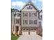 Charming three-story townhome with a brick foundation and a two-car garage at 300 Trecastle Ln # 26, Canton, GA 30114