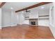 Spacious living room with fireplace, wood beams, and hardwood floors at 300 Trecastle Ln # 26, Canton, GA 30114