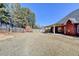 Large backyard with a privacy fence, convenient storage shed, and covered patio space at 337 Inverness Ave, Mcdonough, GA 30253