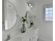 Bright bathroom with double vanity, framed mirror, and tiled floors at 337 Inverness Ave, Mcdonough, GA 30253