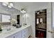 Bathroom with double sink vanity and framed mirror leading to bedroom at 337 Inverness Ave, Mcdonough, GA 30253