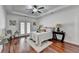 Serene main bedroom with hardwood floors, french doors, ceiling fan, tray ceiling, and ample natural light at 337 Inverness Ave, Mcdonough, GA 30253