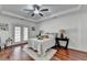Tranquil main bedroom retreat featuring tray ceiling, hardwood floors and french doors with bedside tables at 337 Inverness Ave, Mcdonough, GA 30253