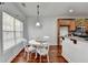 Charming dining area with natural light, featuring a round table, and seamless access to the kitchen area at 337 Inverness Ave, Mcdonough, GA 30253