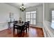 Elegant dining room with hardwood floors, wainscoting, and natural light, perfect for Gathering meals at 337 Inverness Ave, Mcdonough, GA 30253