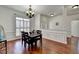 Spacious dining area with hardwood floors and white trim, open to other living spaces at 337 Inverness Ave, Mcdonough, GA 30253
