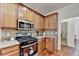 Modern kitchen with wood cabinets, granite countertops, stainless steel appliances, and tiled backsplash at 337 Inverness Ave, Mcdonough, GA 30253