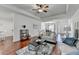 Inviting living room with hardwood floors, stylish rug, and comfortable seating, open to dining area, perfect for gatherings at 337 Inverness Ave, Mcdonough, GA 30253