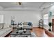 Bright living room boasts hardwood floors, modern furniture, and a cozy atmosphere with fireplace and decorations at 337 Inverness Ave, Mcdonough, GA 30253