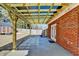 Covered patio with wooden beams and brick exterior overlooking the backyard at 337 Inverness Ave, Mcdonough, GA 30253