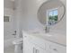 Elegant bathroom with white vanity, round mirror, and tiled shower with niche at 302 Trecastle Ln # 27, Canton, GA 30114