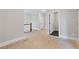 Hallway featuring an open doorway, access to stairs and light grey walls with white trim at 302 Trecastle Ln # 27, Canton, GA 30114