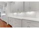 Bright kitchen features white cabinets and drawers with under cabinet lighting and quartz countertops at 302 Trecastle Ln # 27, Canton, GA 30114