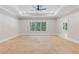 Expansive main bedroom featuring a tray ceiling, fan, and large window with a view of the trees at 302 Trecastle Ln # 27, Canton, GA 30114