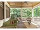 Cozy covered porch with comfortable seating, wooden floors, a ceiling fan and view of the trees at 302 Trecastle Ln # 27, Canton, GA 30114