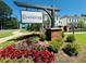 Evanshire community entrance with lush landscaping and welcoming signage at 3117 Moor View Rd # 36, Duluth, GA 30096