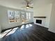 Bright living room featuring a fireplace, ceiling fan, and a door to an outdoor deck at 3117 Moor View Rd # 36, Duluth, GA 30096