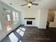 Cozy living room featuring a fireplace, ceiling fan, and a door to an outdoor deck at 3117 Moor View Rd # 36, Duluth, GA 30096