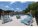 Community pool with multiple lounge chairs and umbrellas on a sunny day at 3117 Moor View Rd # 36, Duluth, GA 30096