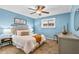 Bedroom with blue walls, ceiling fan, and decorative furnishings at 343 8Th Ne St # G2, Atlanta, GA 30309