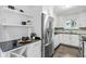 Well-designed white kitchen features stainless steel appliances, dark countertops, and ample storage for a functional space at 343 8Th Ne St # G2, Atlanta, GA 30309