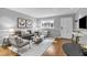 Cozy living room with light-filled window features hardwood floors, gray walls with white trim, and comfortable seating at 343 8Th Ne St # G2, Atlanta, GA 30309