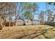 Spacious backyard with a patio area, fenced perimeter, and mature trees providing shade and privacy at 6071 Cristie Dr, Ellenwood, GA 30294