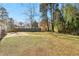 A view of the backyard and patio with mature trees, offering a private outdoor space at 6071 Cristie Dr, Ellenwood, GA 30294