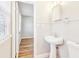 Cozy bathroom featuring a pedestal sink, modern fixtures, and a view of the next room at 6071 Cristie Dr, Ellenwood, GA 30294