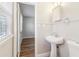 Bright bathroom featuring a pedestal sink, modern fixtures, and a view of the next room at 6071 Cristie Dr, Ellenwood, GA 30294