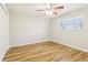 Bedroom featuring closet, ceiling fan, light walls, light wood-look flooring, and a window with blinds at 6071 Cristie Dr, Ellenwood, GA 30294