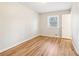 Bedroom featuring light walls, light wood-look flooring, and a window at 6071 Cristie Dr, Ellenwood, GA 30294