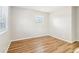 Bedroom featuring light walls, light wood-look flooring, and a window with blinds at 6071 Cristie Dr, Ellenwood, GA 30294