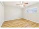 This light and airy bedroom showcases wood-look floors and a ceiling fan at 6071 Cristie Dr, Ellenwood, GA 30294