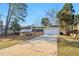 Traditional home featuring a well-manicured lawn, attached garage, and classic architectural details at 6071 Cristie Dr, Ellenwood, GA 30294