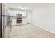 Well-lit kitchen features white cabinetry, stainless steel appliances, and durable tile flooring at 6071 Cristie Dr, Ellenwood, GA 30294