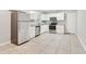 Well-lit kitchen featuring stainless steel appliances, white cabinetry, and tile flooring at 6071 Cristie Dr, Ellenwood, GA 30294