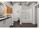 Bathroom featuring modern vanities, black floors, and a glass shower at 878 Peachtree Ne St # 431, Atlanta, GA 30309